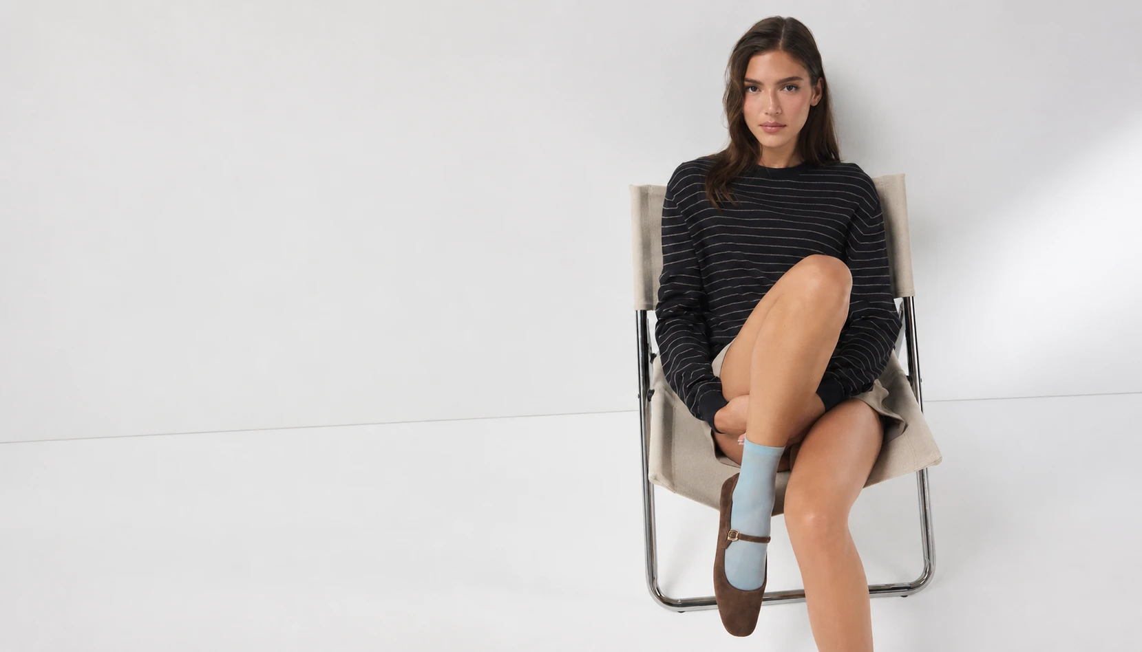 Model wearing ALDO brown Mary Jane flats and blue socks